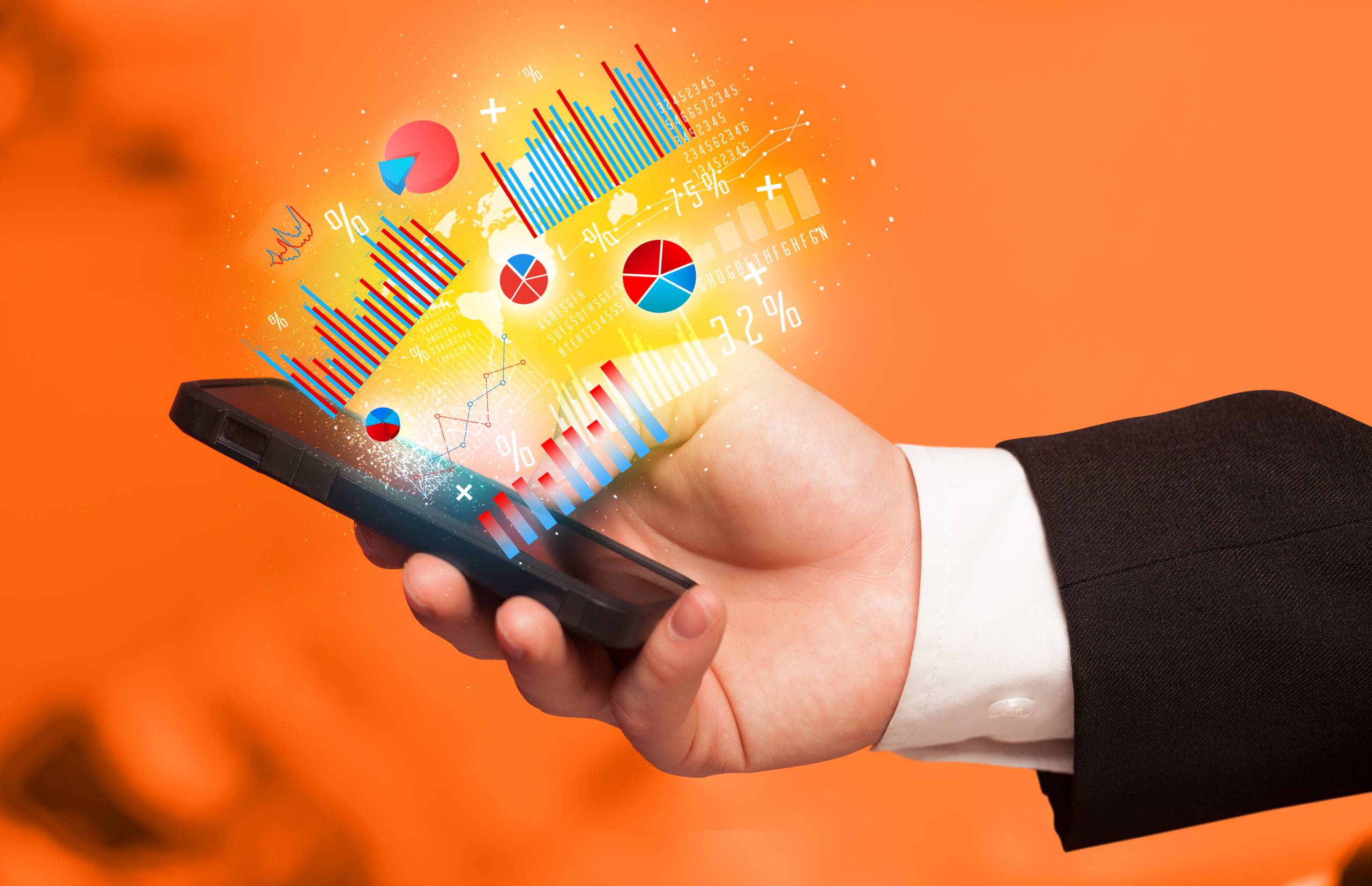Business man holding smartphone with chart symbols